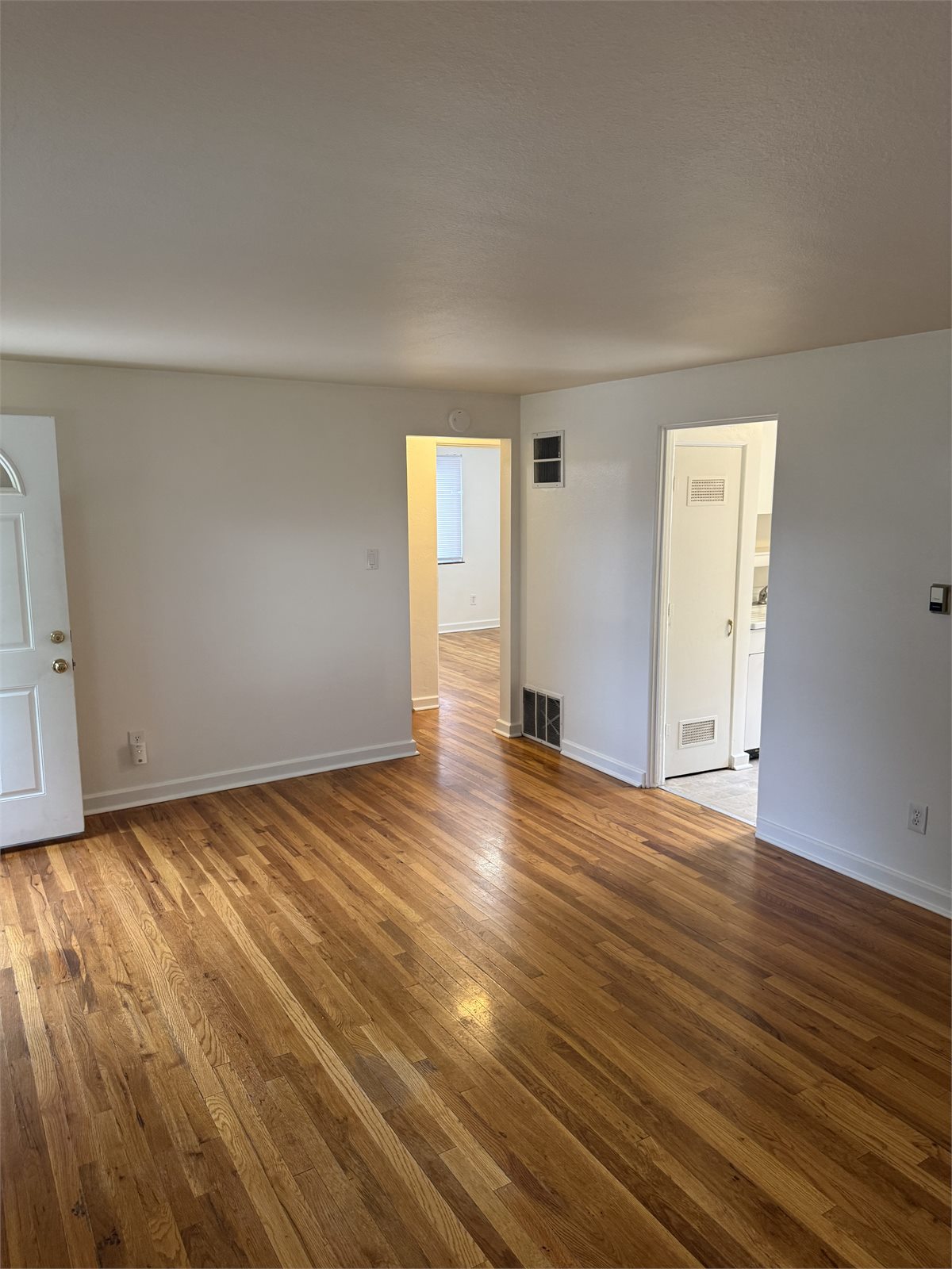 Bright living room at 1311 E. Caramillo Street with hardwood floors